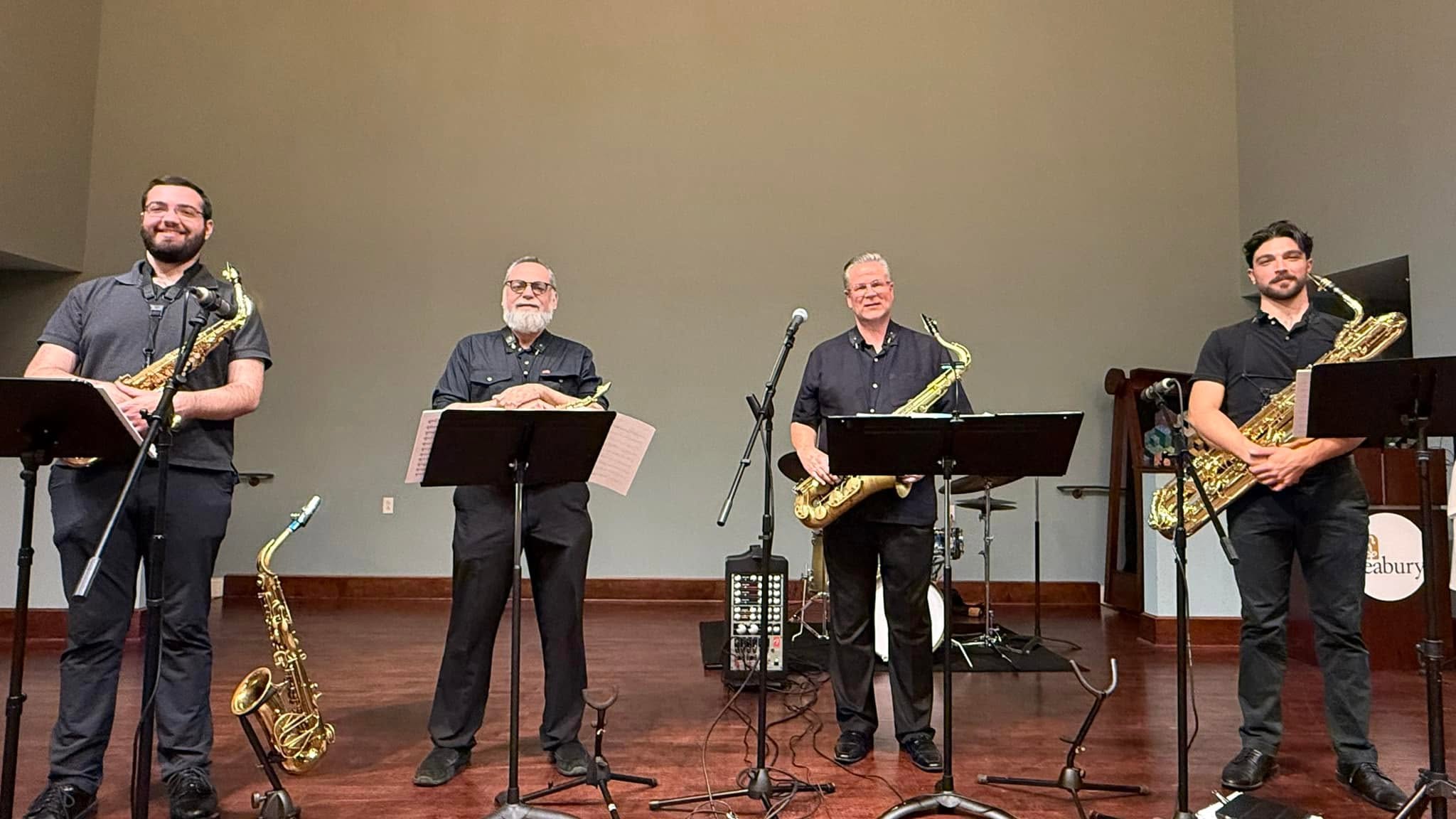 Infinity Saxophone Quartet group photo at a concert